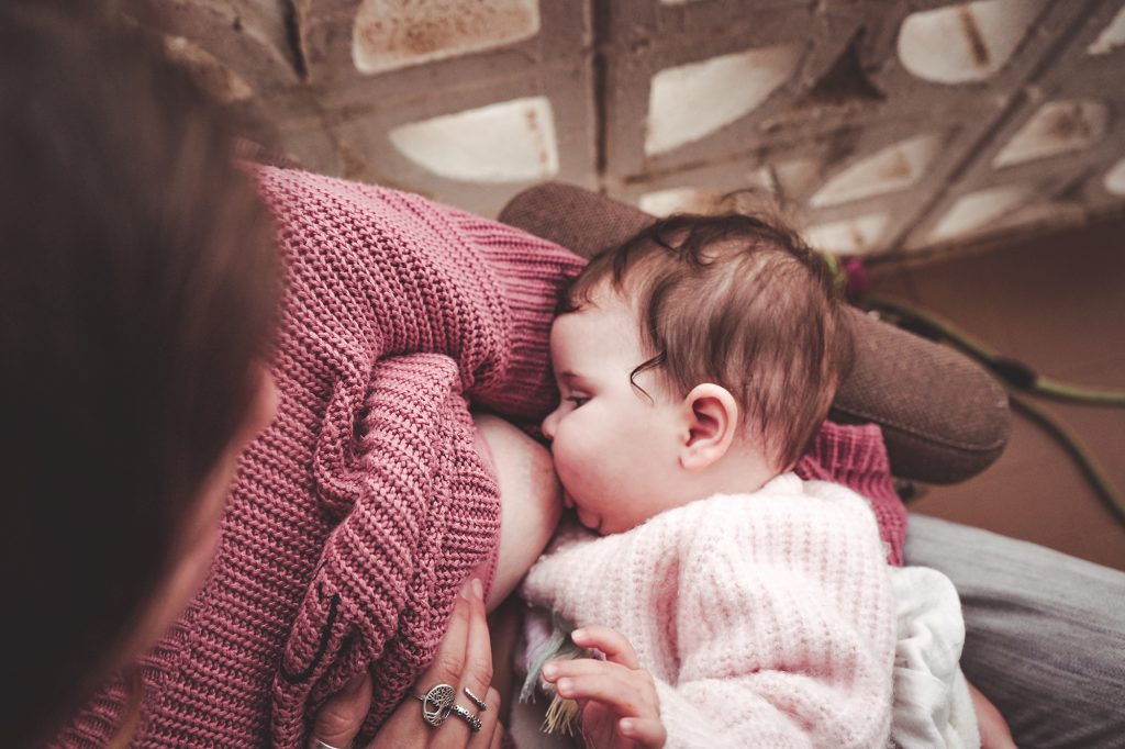 Young woman breastfeeding her baby